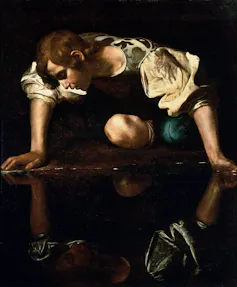 A man transfixed by his own reflection.
