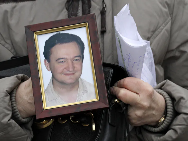 Nataliya Magnitskaya holds a portrait of her son, Russian lawyer Sergei Magnitsky, a lawyer who died in jail,