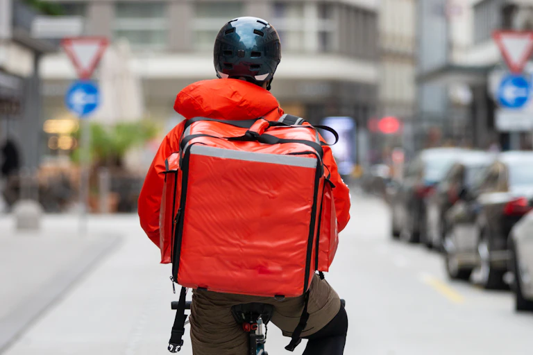 A courier on bicycle delivering food
