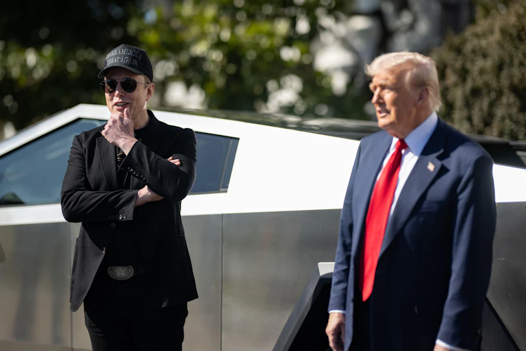 Elon Musk and Donald Trump stand in front a car.