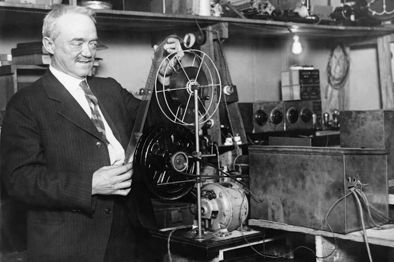 Television pioneer Charles Francis Jenkins inspecting his broadcasting apparatus in 1928.