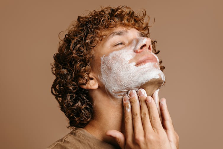 What's an ‘alpha’ male? 1 A young man applying a face mask
