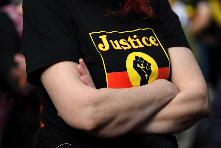 A black, yellow and red t-shirt with the words