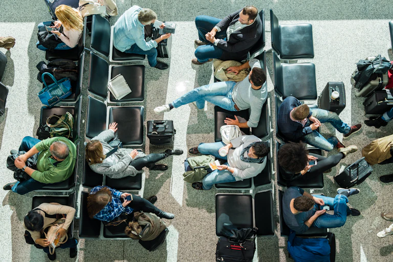 A birds-eye view of people waiting in an airport lounge.