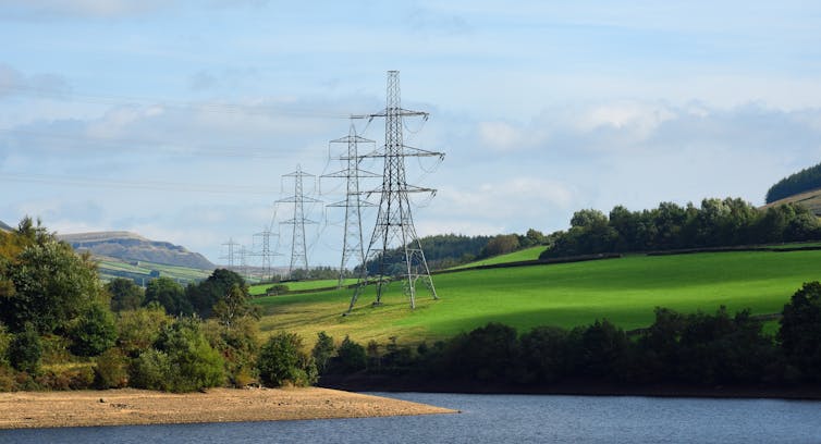 Pylons in fields above reservoir