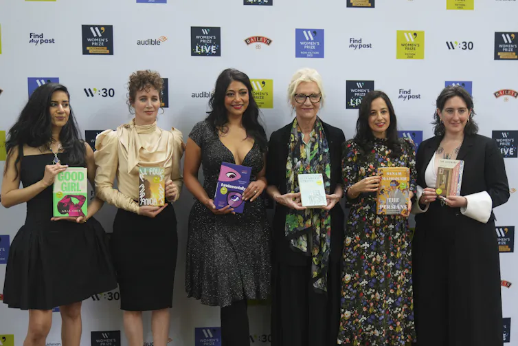 Women in a line holding books