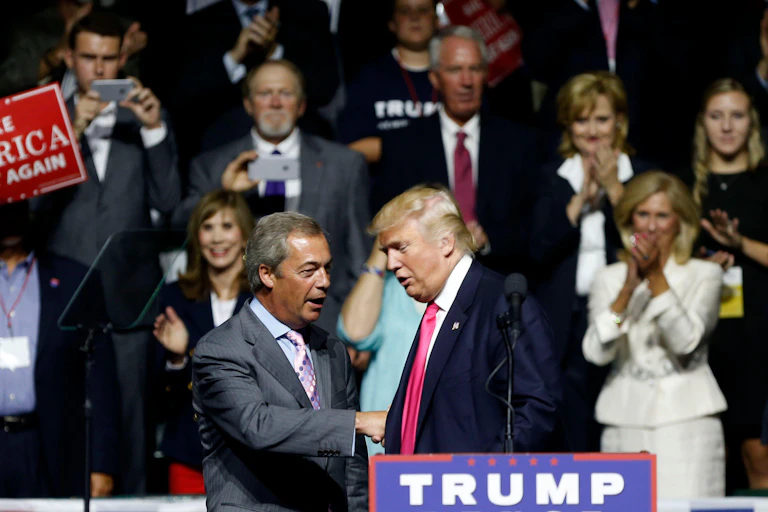 Nigel Farage and Donald Trump on a stage at a campaign rally in 2016.
