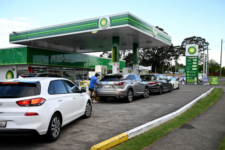 Cars queued up at a petrol station
