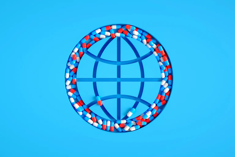Illustration of debossed globe with longitude and latitude lines, pill capsules filling the circumference