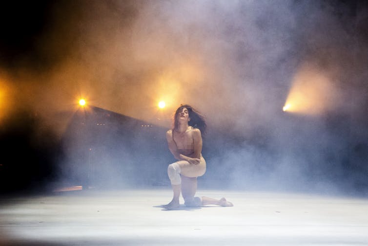 A naked woman on stage.