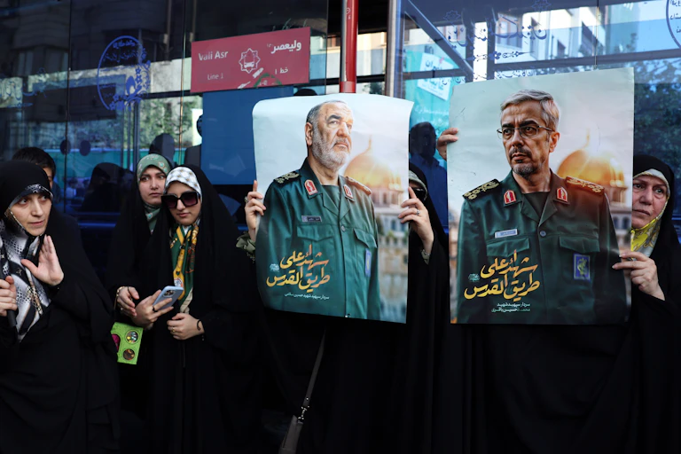 Iranians hold posters of late Islamic Revolutionary Guard Corps head Hossein Salami, and late Iranian Armed Forces Chief of Staff General Mohammad Bagheri during an anti-Israeli rally in Tehran, Iran, 14 June 2025