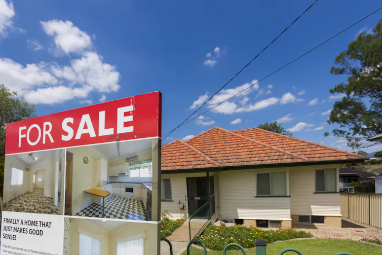 For sale sign in front of a house