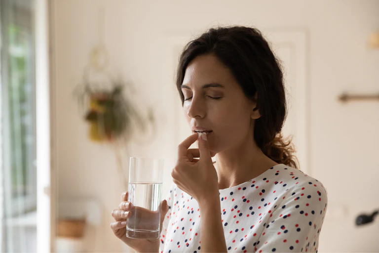 Woman taking painkillers