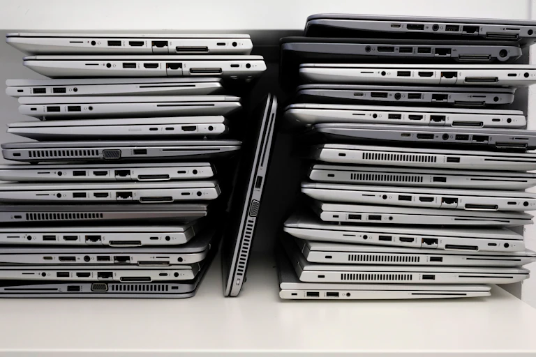 A rack with a stack of laptops.