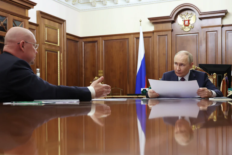Russian President Vladimir Putin attends a meeting with Sevastopol Governor Mikhail Razvozhayev at the Kremlin in Moscow
