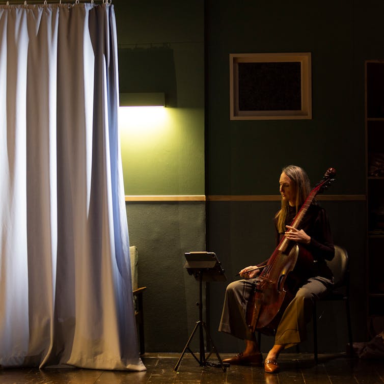Production image: a woman and her cello.
