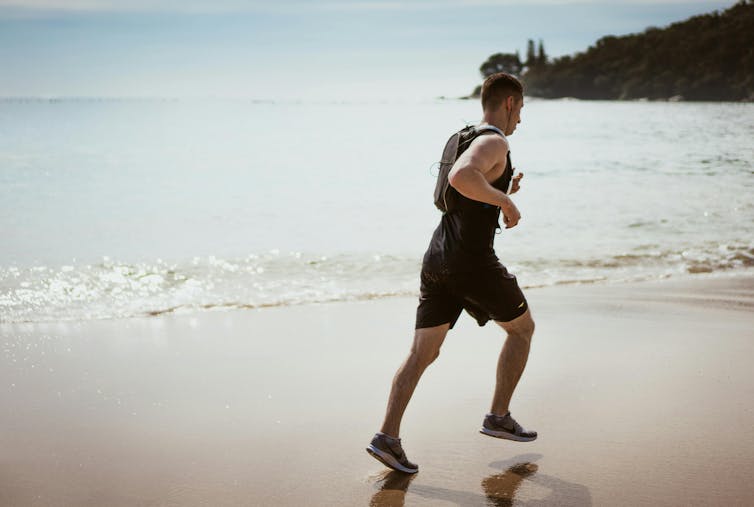 Man jogs on a beach