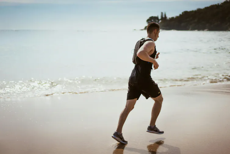 Man jogs on a beach