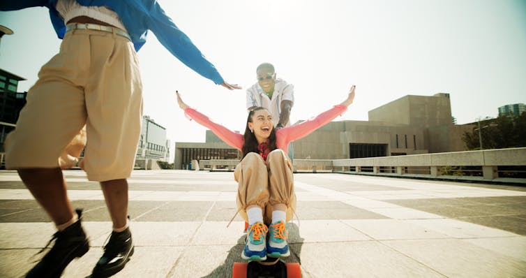 Young people laughing with skateboard