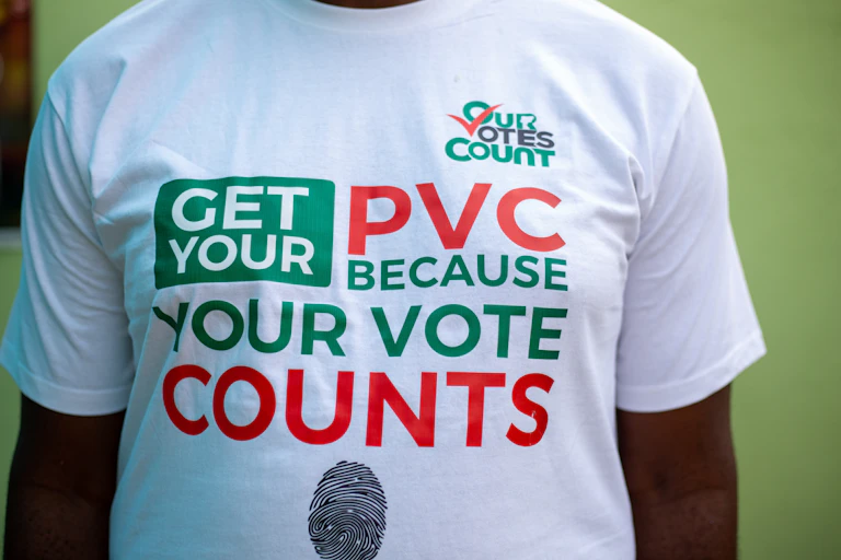 A man wearing a t-shirt that says "your votes count"