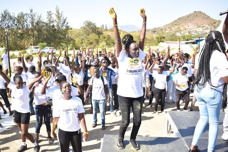 crowd of young people jump up and down
