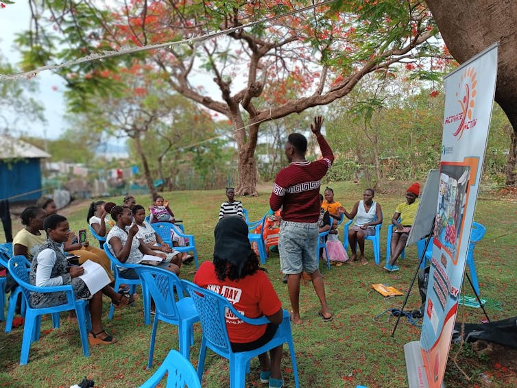 Man gives lecture outside.