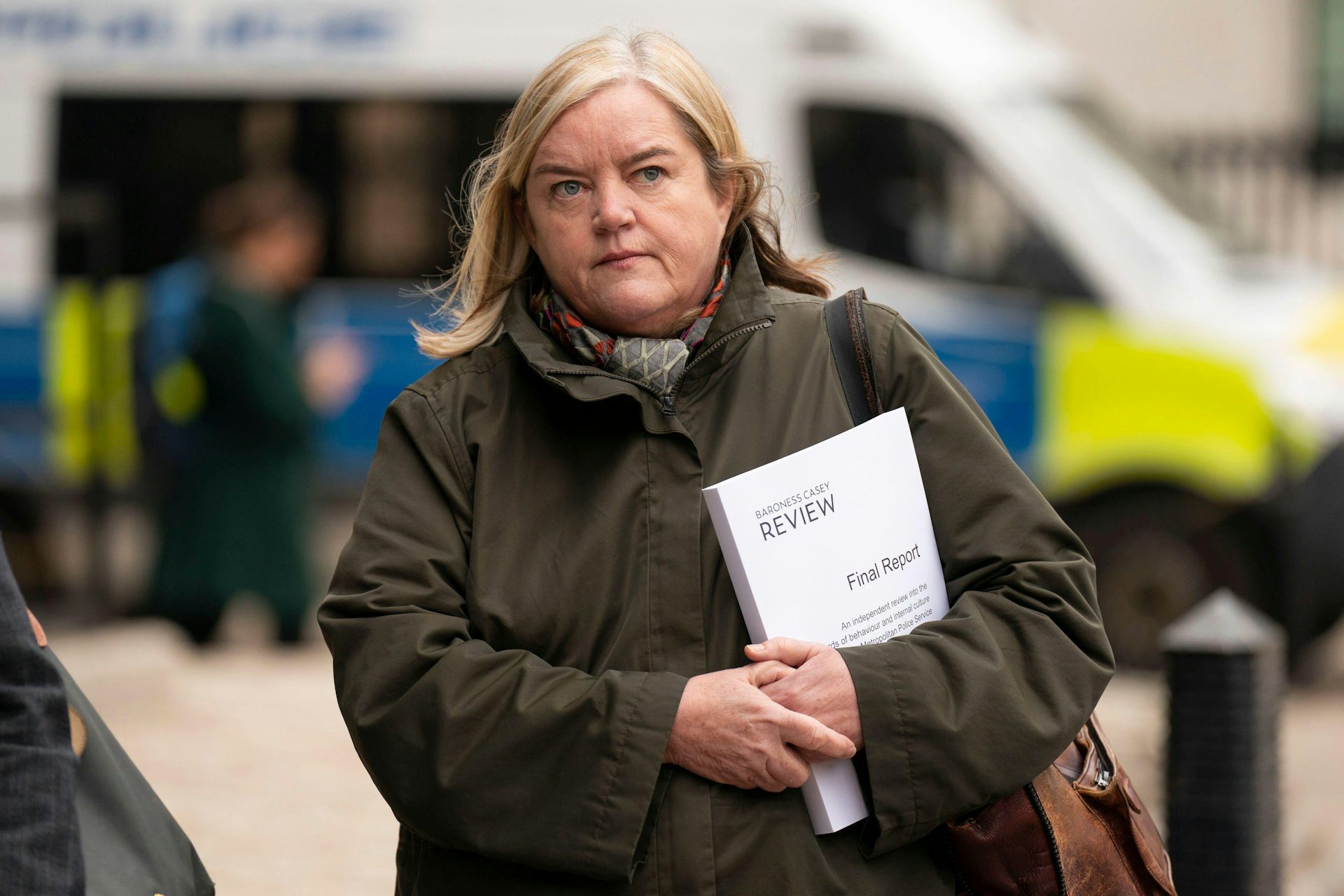 Louise Casey walking with a 'final report' under her arm