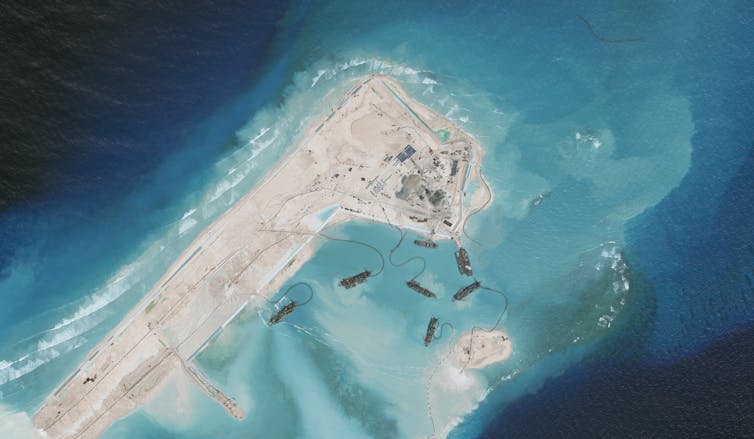 A human-made reef is seen in blue ocean waters.