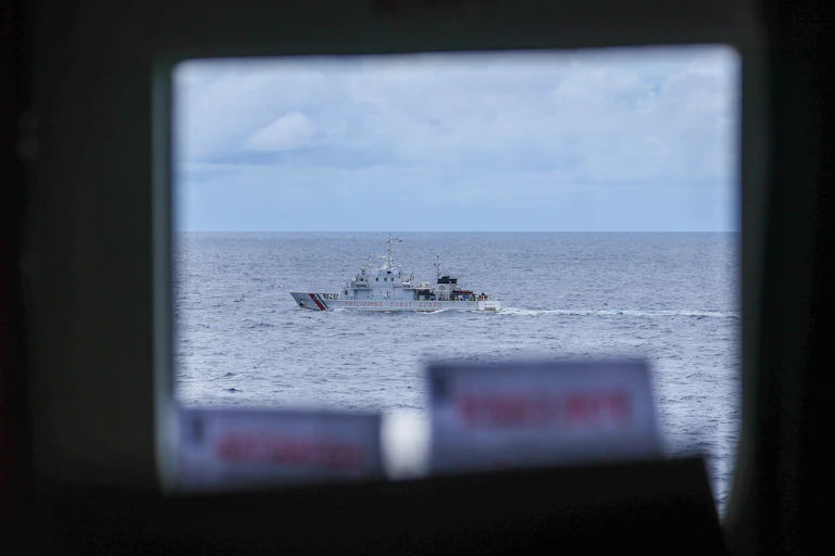 A boat is seen through a wiindow.