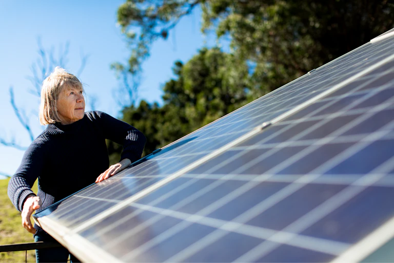 woman looks at solar panels.