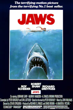 movie poster for 'Jaws' with shark's toothy mouth under the water with a swimmer on the surface
