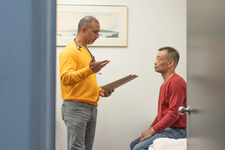 Doctor talks to male patient