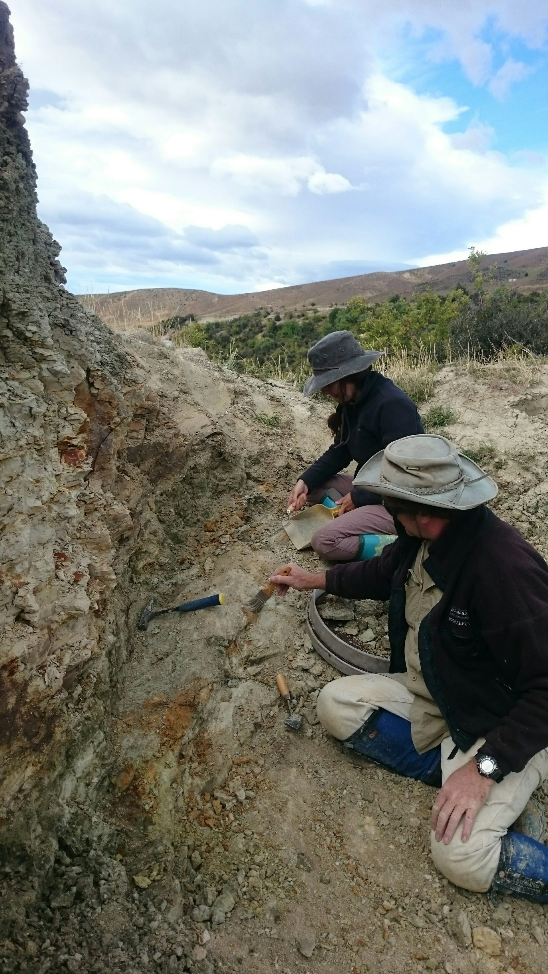 Two people digging for fossils.