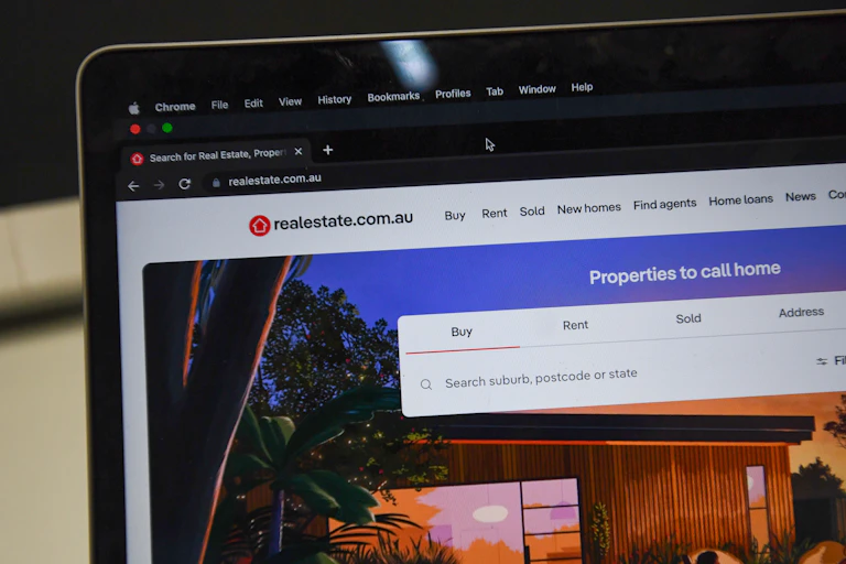 the landing webpage for realestate.com.au seen on a laptop computer