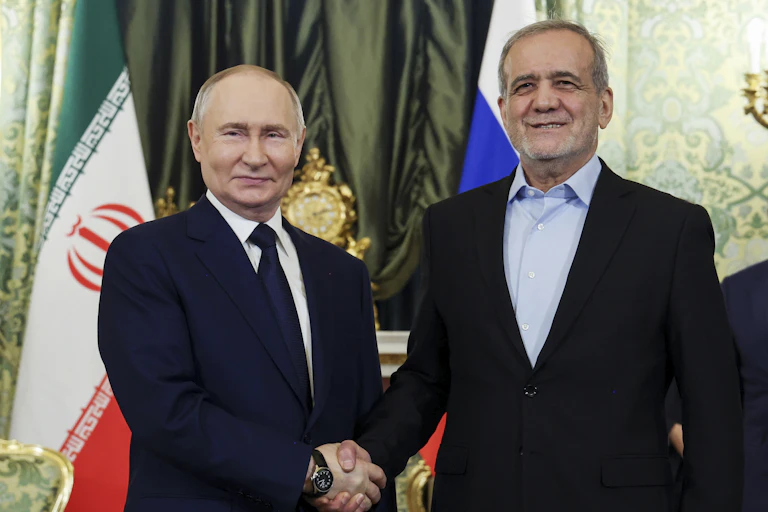 Russian President Vladimir Putin and Iranian President Masoud Pezeshkian pose for a photo