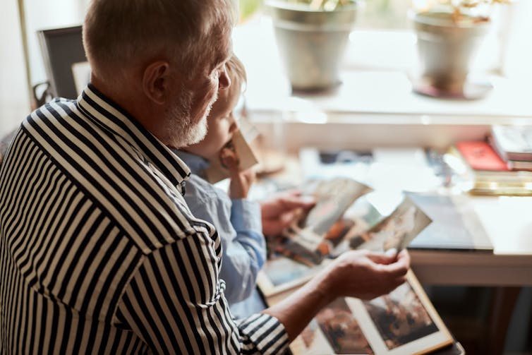 Man shows pictures of his granddaughter