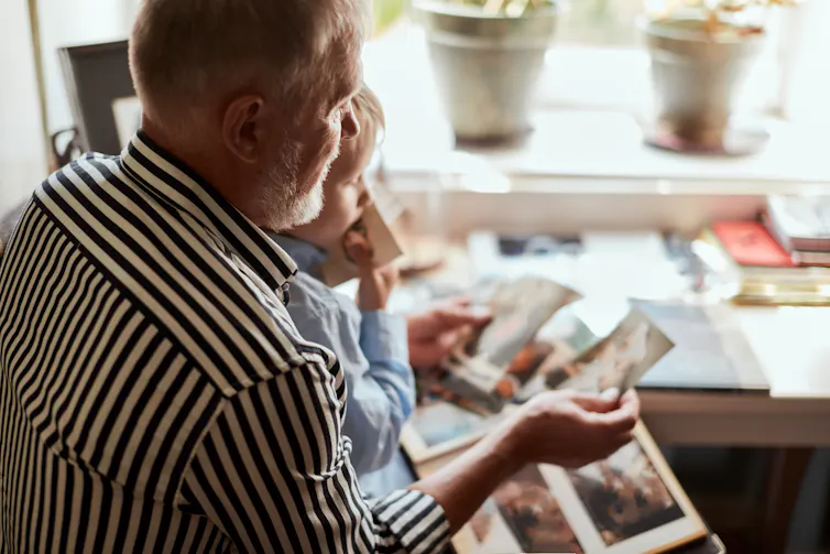 Man shows his grandchild photos