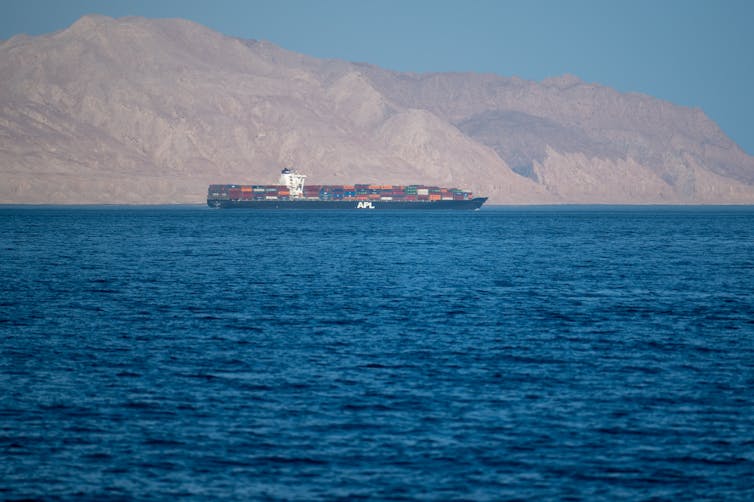 container ship at sea in the strait of hormuz between iran and oman