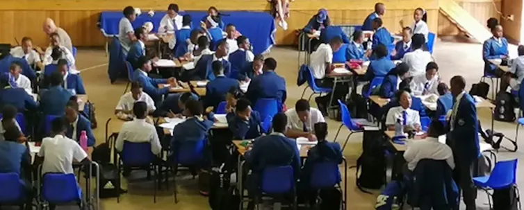 Children in school uniforms working at desks