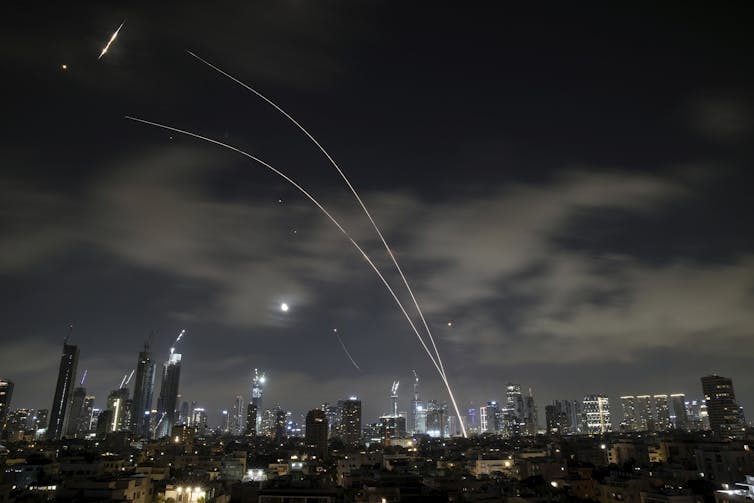Rayos de luz en el cielo nocturno sobre la ciudad.