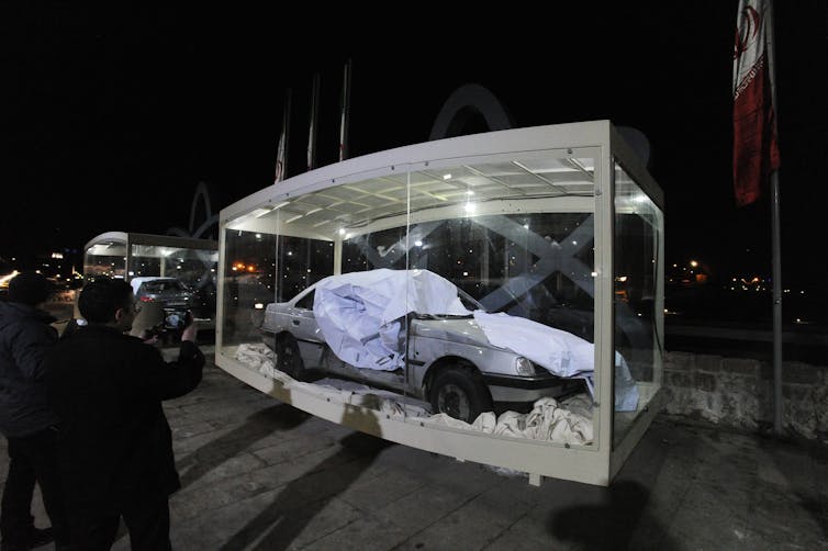A damaged car at the scene of explosion.