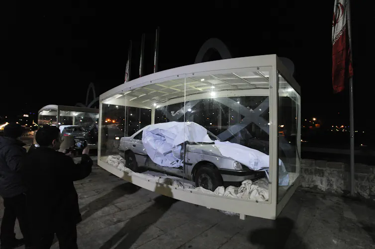 A damaged car at the scene of explosion.