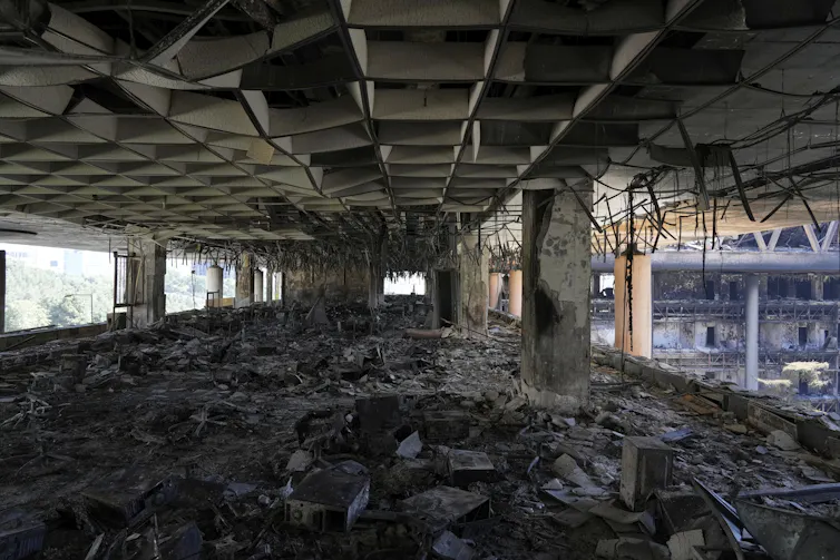 An interior photograph of the rubble of a destroyed building.