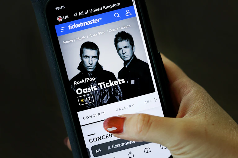phone screen showing ticketmaster site and oasis tickets for sale