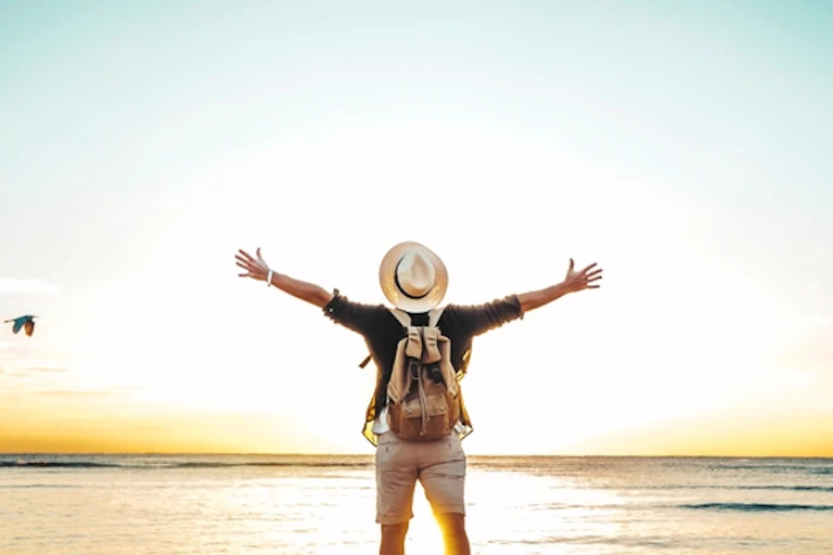 Back view of a man raising his arms in exultation.