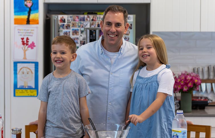 A smiling Jim Chalmers with his son and daughter.