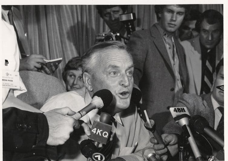 Archival photo: Joh talks to the press.