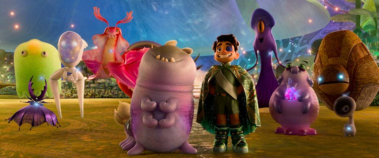An animated still showing a young boy with an eye patch and a strange colourful assortment of alien creatures.