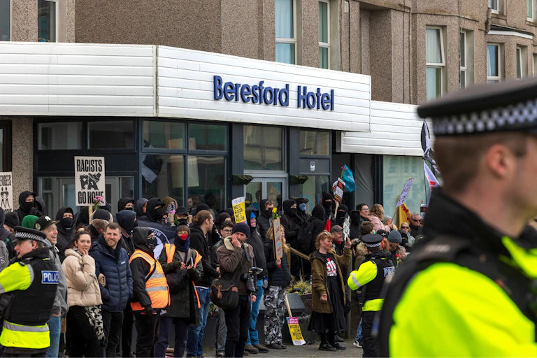 Police and protesters outside Beresford Hotel