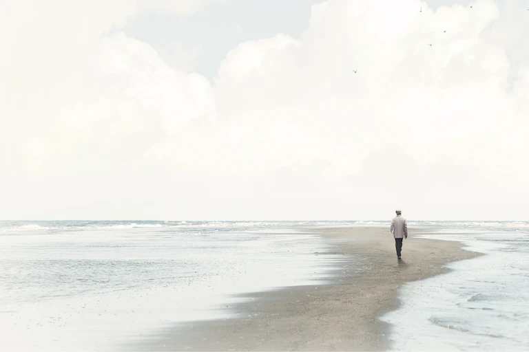 A person walks between two bodies of water.